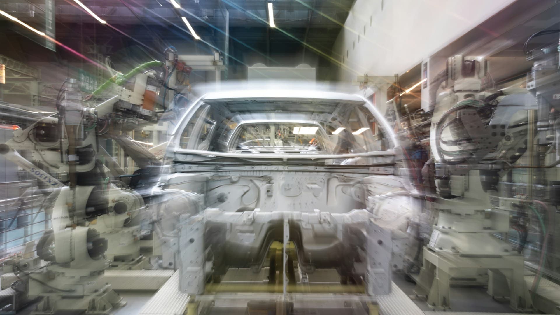Automotive assembly line with robotic arms